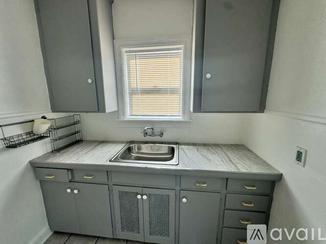 A kitchen with a sink and cabinets.