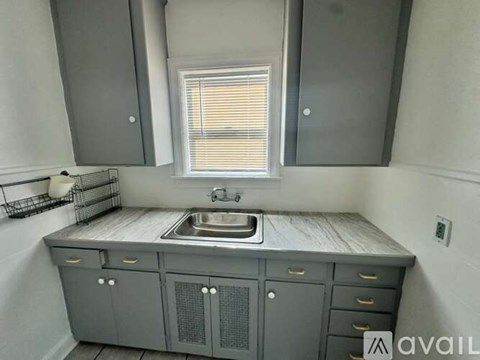 A kitchen with a sink and cabinets.