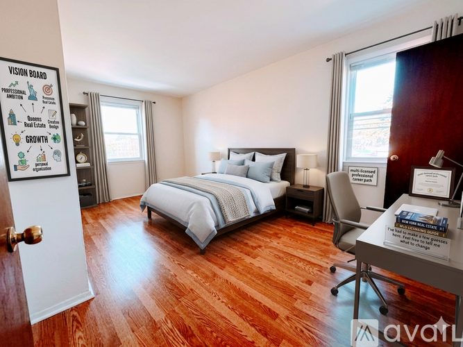A bedroom with a bed, desk, and chair.