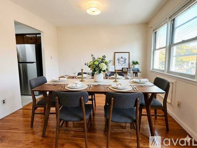 A dining room with a table set for six people.