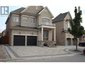 A large, two-story house with a stone exterior and a garage.