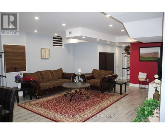 A living room with a brown sofa and a coffee table.