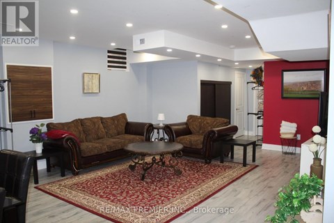 A living room with a brown sofa and a coffee table.