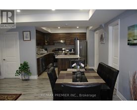 A kitchen with a table and chairs in the middle of the room.
