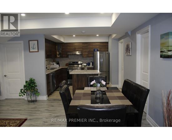A kitchen with a table and chairs in the middle of the room.