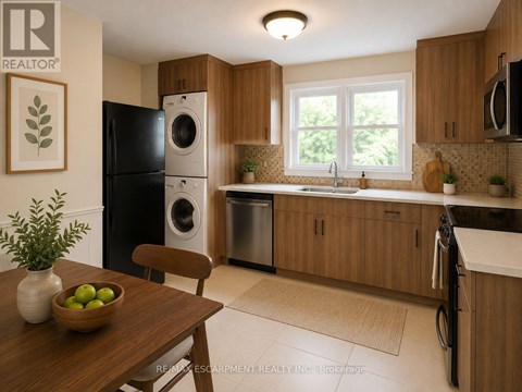 A kitchen with wooden cabinets and a black fridge.