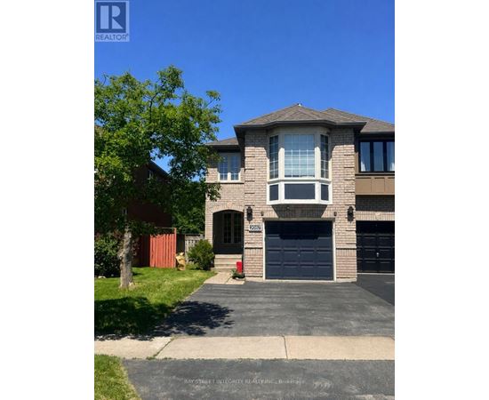 A two-story house with a garage is for sale.