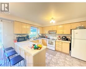 A kitchen with a white refrigerator, white stove, and white countertops.