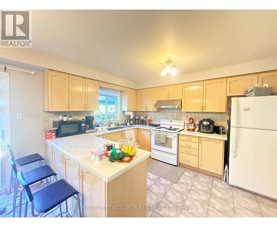 A kitchen with a white refrigerator, white stove, and white countertops.