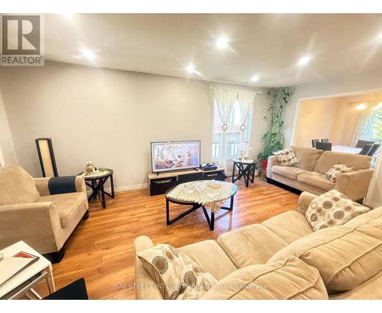 A living room with a television and a couch.