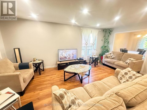 A living room with a television and a couch.