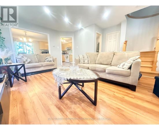 A living room with a white couch and a coffee table.