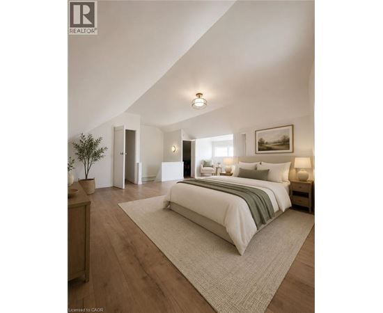 A bedroom with a large bed and a painting on the wall.