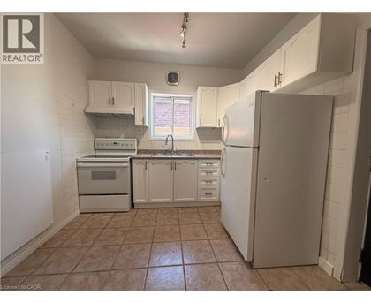 A kitchen with white cabinets and appliances.