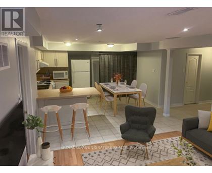 A well-lit kitchen with a dining table and chairs.
