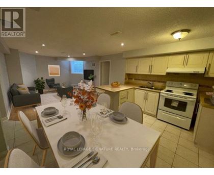 A dining room with a table set for a meal.