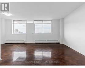 Empty room with white walls and wood flooring.