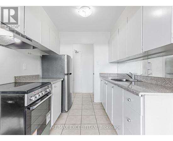 A kitchen with white cabinets and a black stove top oven.