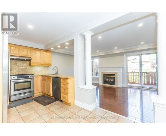 A kitchen with wooden cabinets and a black stove top oven.