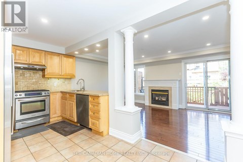 A kitchen with wooden cabinets and a black stove top oven.
