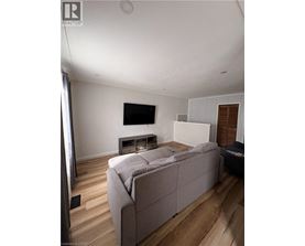 A room with wooden floors and a white ceiling with a light fixture.