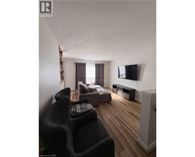 A room with wooden flooring and a window.