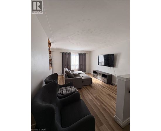 A room with wooden flooring and a window.