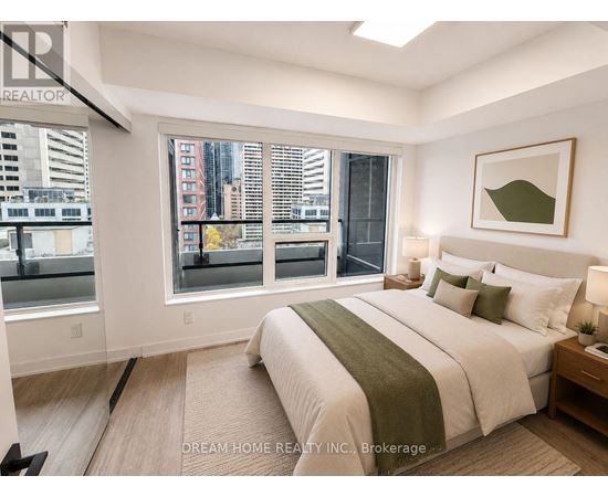 A bedroom with a large bed and a view of the city.