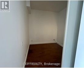 A room with white walls and wooden flooring.