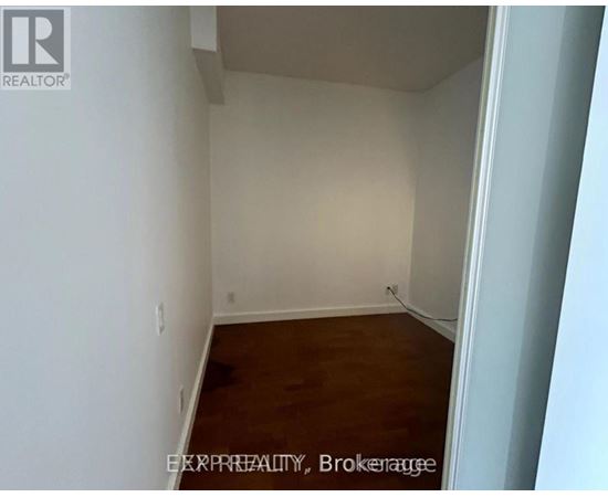 A room with white walls and wooden flooring.