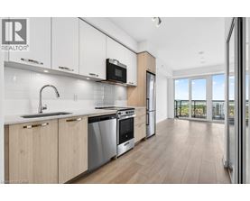 A modern kitchen with wooden cabinets and stainless steel appliances.