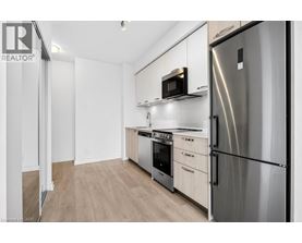 A modern kitchen with stainless steel appliances and wooden cabinets.
