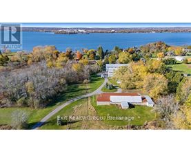 A brochure for Exit Realty Group Brokerage shows a rural landscape with a house and a body of water.