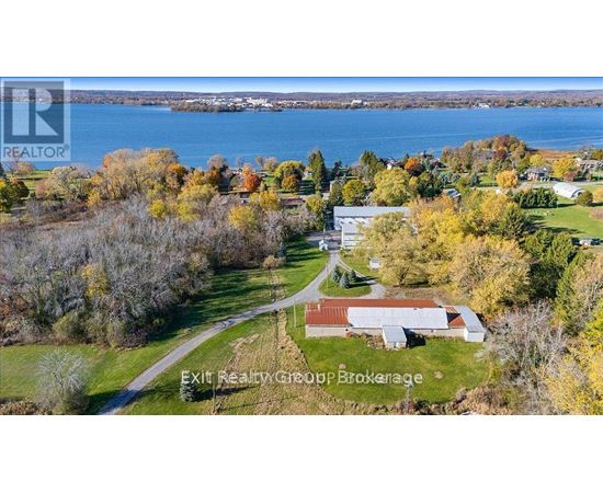 A brochure for Exit Realty Group Brokerage shows a rural landscape with a house and a body of water.