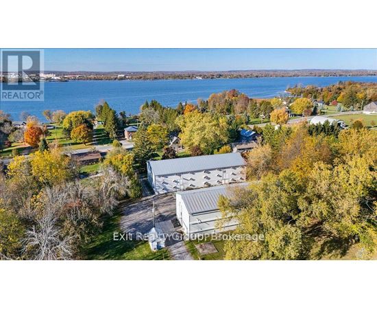A real estate company's brochure image of a house surrounded by trees.