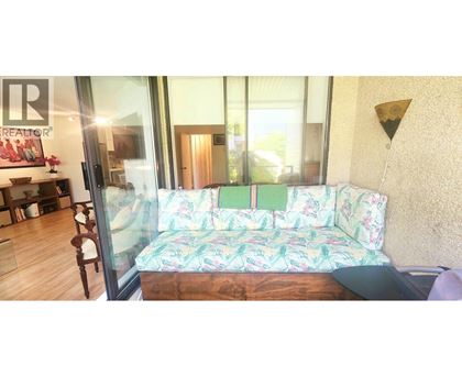A living room with a couch and a glass door.
