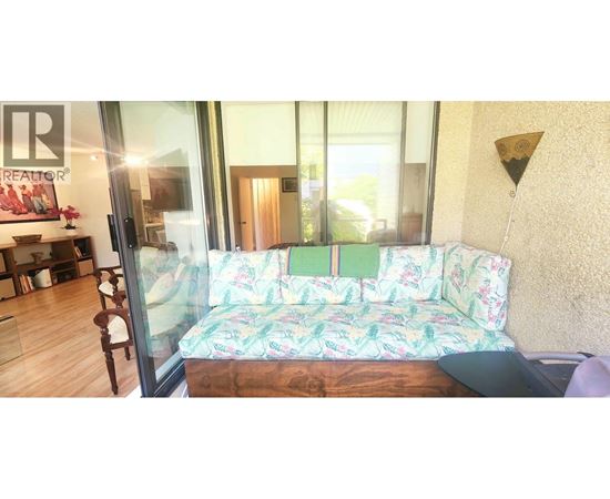 A living room with a couch and a glass door.