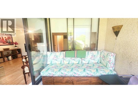 A living room with a couch and a glass door.