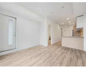 A room with a wooden floor and white walls.