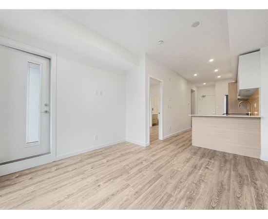 A room with a wooden floor and white walls.