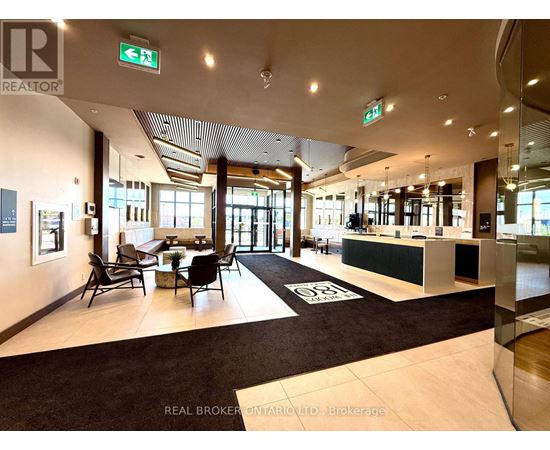 A brokerage office with a black and white carpet and a green reception desk.