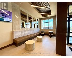 A lobby with a bench and a large window.