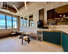 A modern kitchen with a bar area and a view of the outdoors.