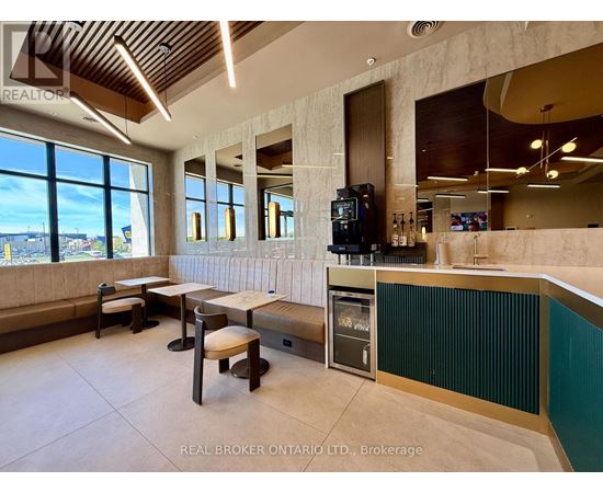 A modern kitchen with a bar area and a view of the outdoors.