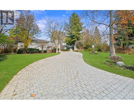A brick pathway leads through a well-kept garden.