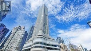 A tall skyscraper with a pointed top is the focal point of the image.