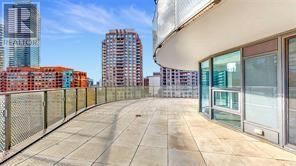 A sidewalk leads to a building with a glass facade and a sign that says "REALFOR".