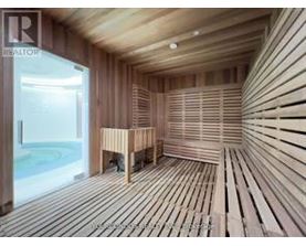 A sauna room with wooden walls and flooring.