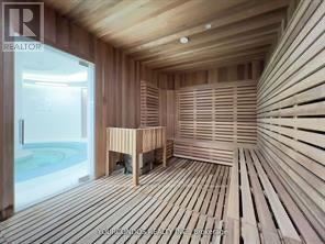 A sauna room with wooden walls and flooring.