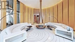 A white circular room with a spiral design on the floor.
